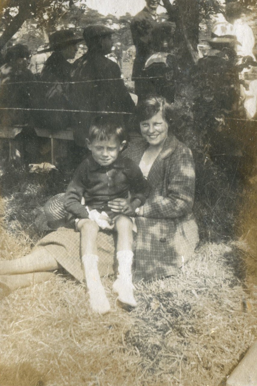 Young boy seated on woman's lap, Hassocks, 1920