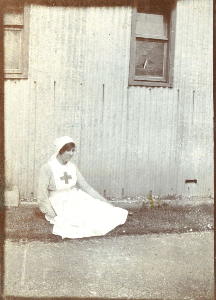 Nurse sitting outside tin hut, probably Tin Town, Brockenhurst