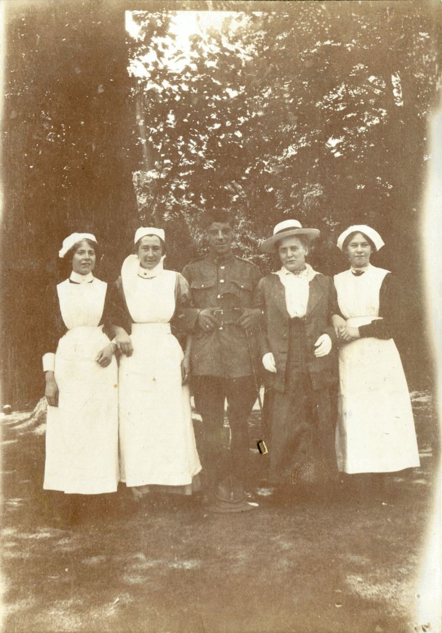 First World War soldier surrounded by four ladies