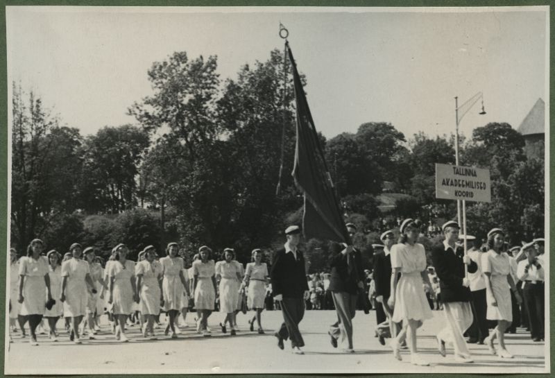 XII üldlaulupidu 28.-29. juunil 1947, Tallinnas.
Tallinna akadeemilised koorid 12. üldlaulupeo rongkäigul Vabaduse väljakul. Eesreas lipukandjad, tagant liiguvad järgi valgesse riietatud naiskoori lauljad.