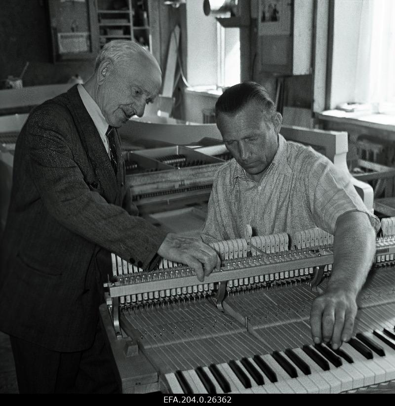 Main engineer of the Tallinn Klaver factory e. Hiis (left) and regulator h. Hallik at the finishing piano Estonia.