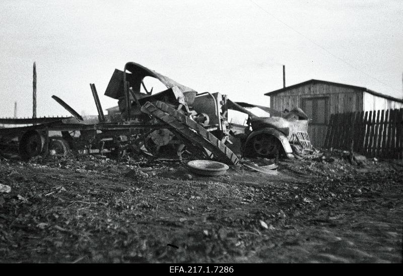 Destroyed German front building material storage area with garage, boiler and barracks.