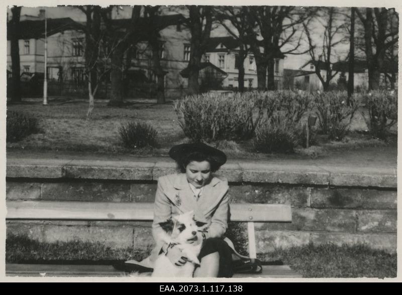 Unidentified woman sitting on parking lot with cork