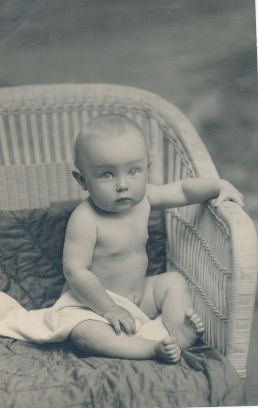 Foto. Väikelaps istumas korvtoolil. O. Siluti kogu. Albumis.