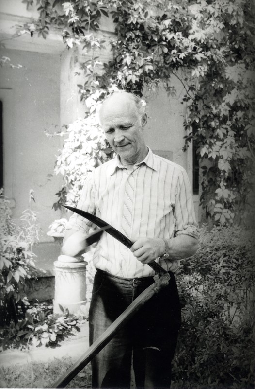 Arnold Allik vikatit luiskamas kantseleihoone ees 1986.a.