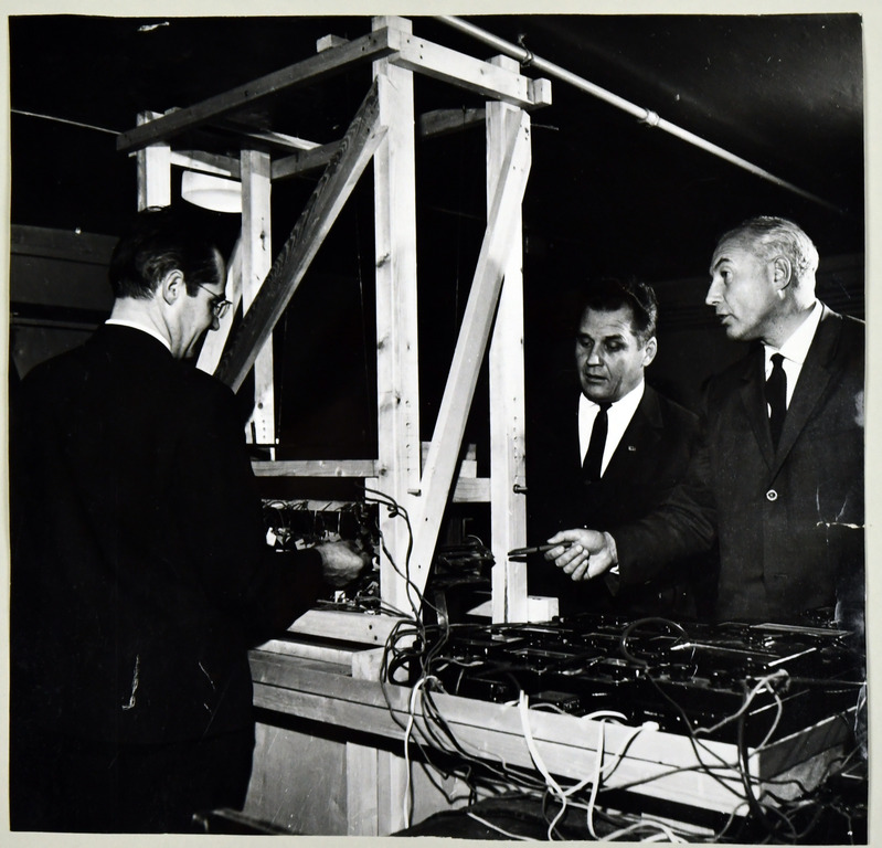 TPI elektriajamite laboratoorium, vasakult E. Risthein, dots. H. Tiismus ja dots. H. Jänes kontrollimas kahepoolse lineaarmootori energeetiliste parameetrite mõõteskeemi, 1973.a.