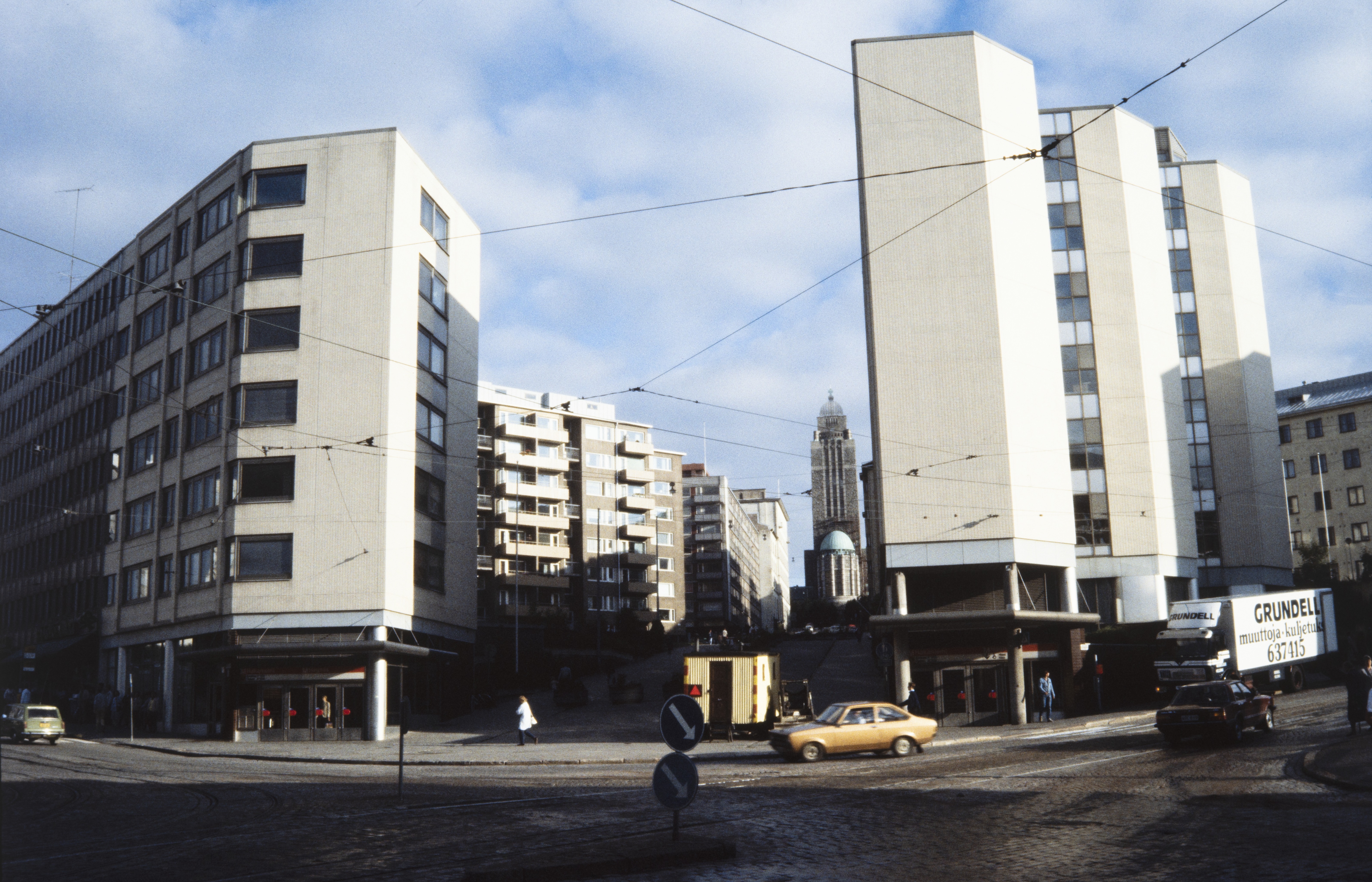 Siltasaarenkatu 13. Rakennusvalvontaviraston toimitalo. Kaupungin rakennuttama Kallion toimistotalot. Jaakko Laapotin vuonna 1979 suunnittelema rakennus valmistui vuonna 1981. Rakennusprojekti toteutettiin KVR-urakkakilpailuna. Siltasaarenkadun päädyssä näkyy Kallion kirkko.