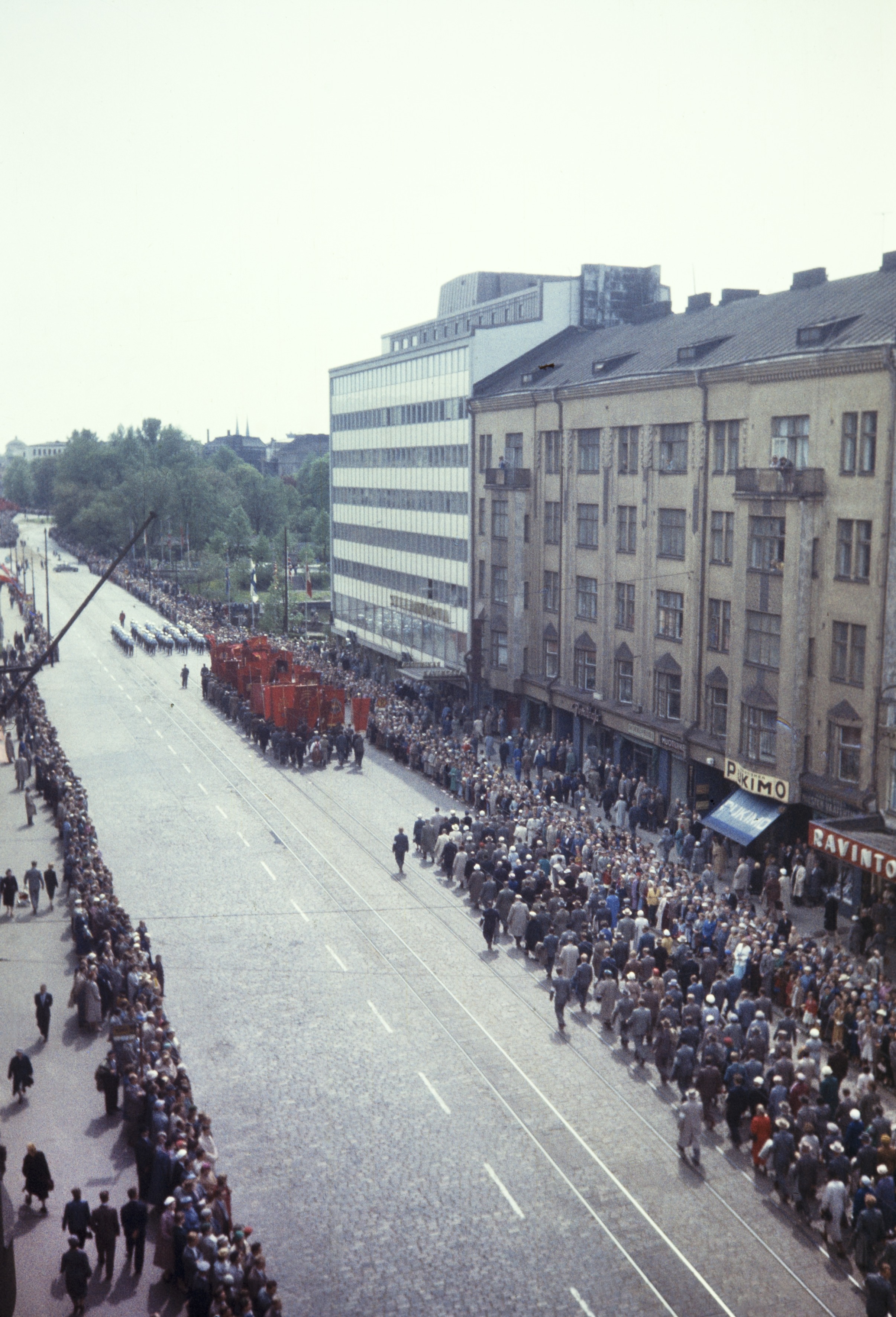 Elanto-lehti. Helluntai 1957, Siltasaarenkatu. Valtakunnallisen ammattiyhdistyslikkeen SAK:n  50-vuotisjuhla. Juhlakulkue marssi ammattiyhdistysliikkeiden lippujen johtamana viisitoistatuhantisena, juhlavana rivistönä läpi Helsingin. Pääjuhla pidettiin stadionilla.