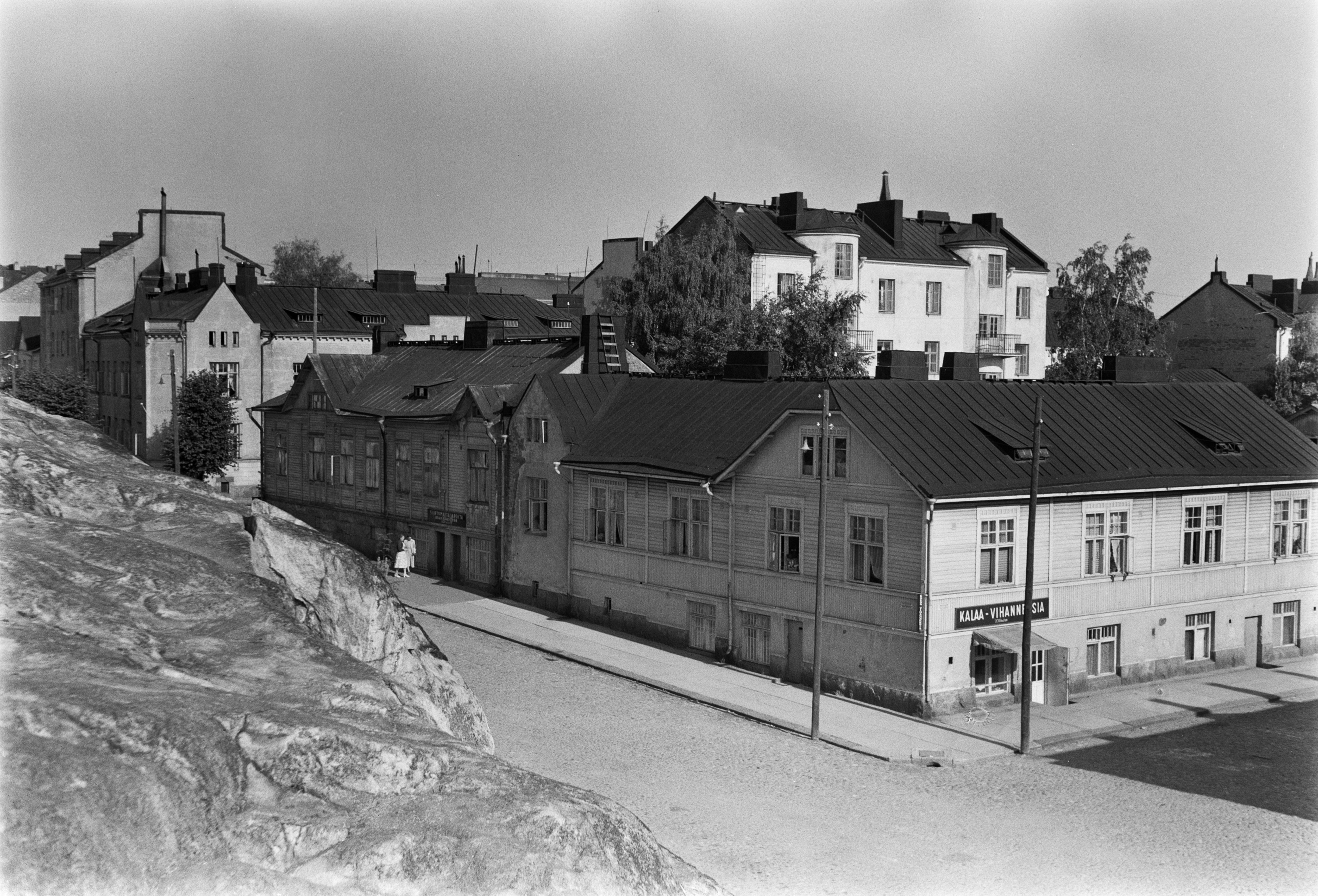 Porvoonkatu 39 ja 41. Kuva otettu Porvoonkadun toiselta puolelta kallioilta. Rakennuksen oikealta puolelta lähtee Inkoonkatu. Kadunkulmassa elintarvikekauppa.