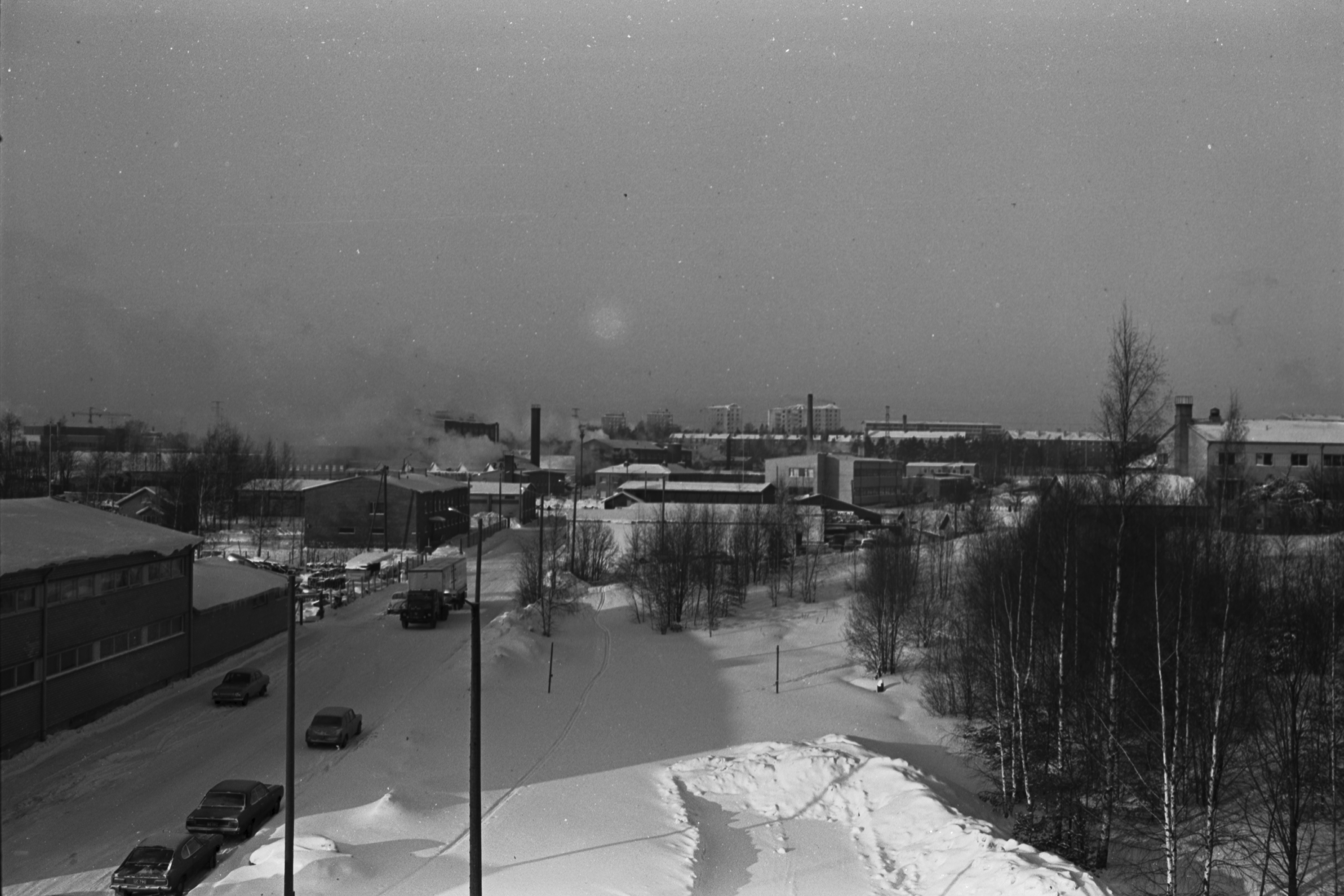 Herttoniemi, talvinen pienteollisuusteollisuusalue.Vasemmalla Puusepänkatu 11, taustalla näkyy Hiihtäjäntien kerrostaloja. Näkymä länteen Sorvaajankadun ja Puusepänkadun risteyksen kohdalta.