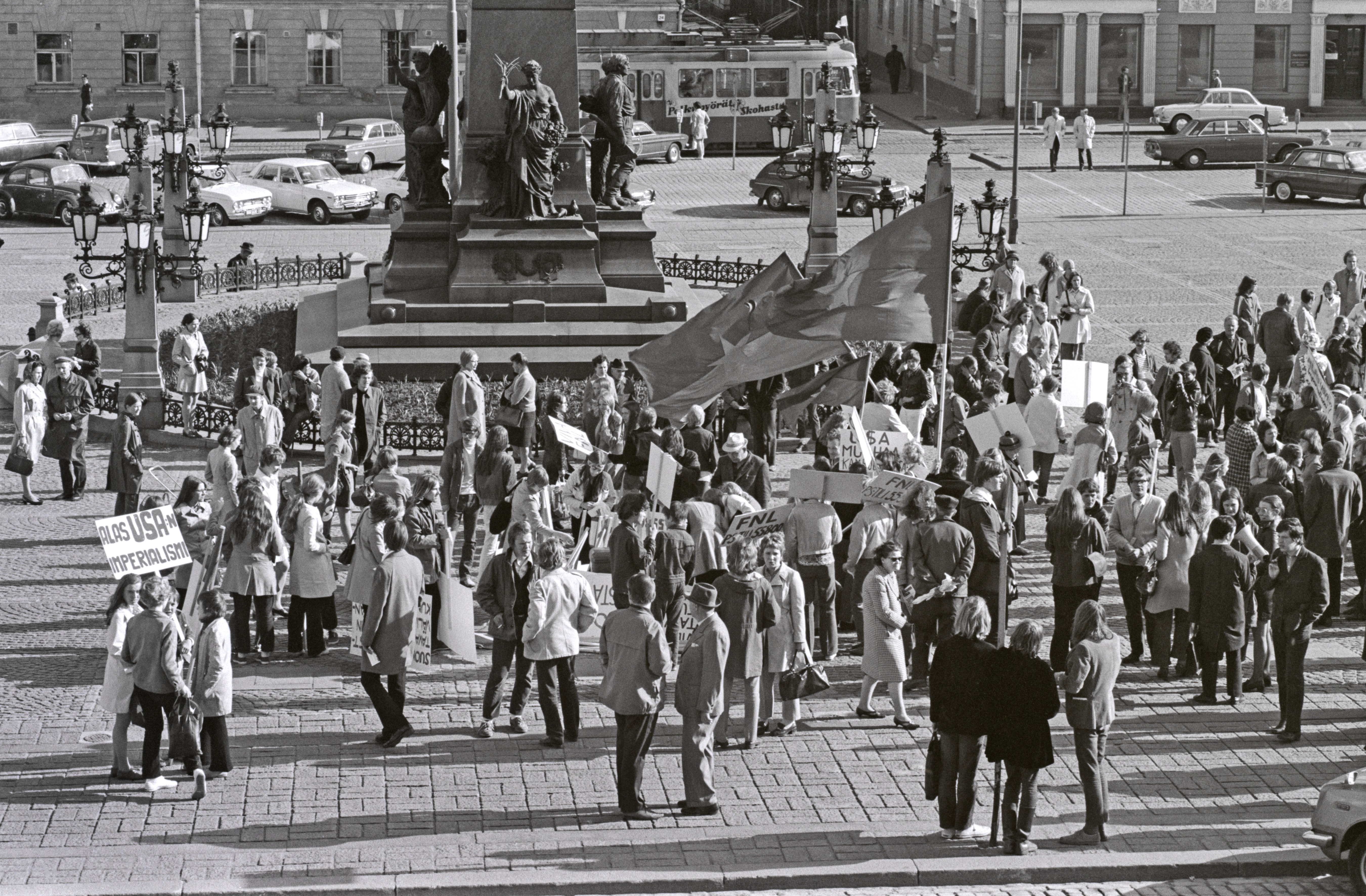 Hallituskatu 7. Ihmisiä kokoontumassa Vietnamin sodan vastaisen mielenosoituskulkueen lähtöpaikalle Senaatintorille Aleksanteri II:n patsaan ympärille.