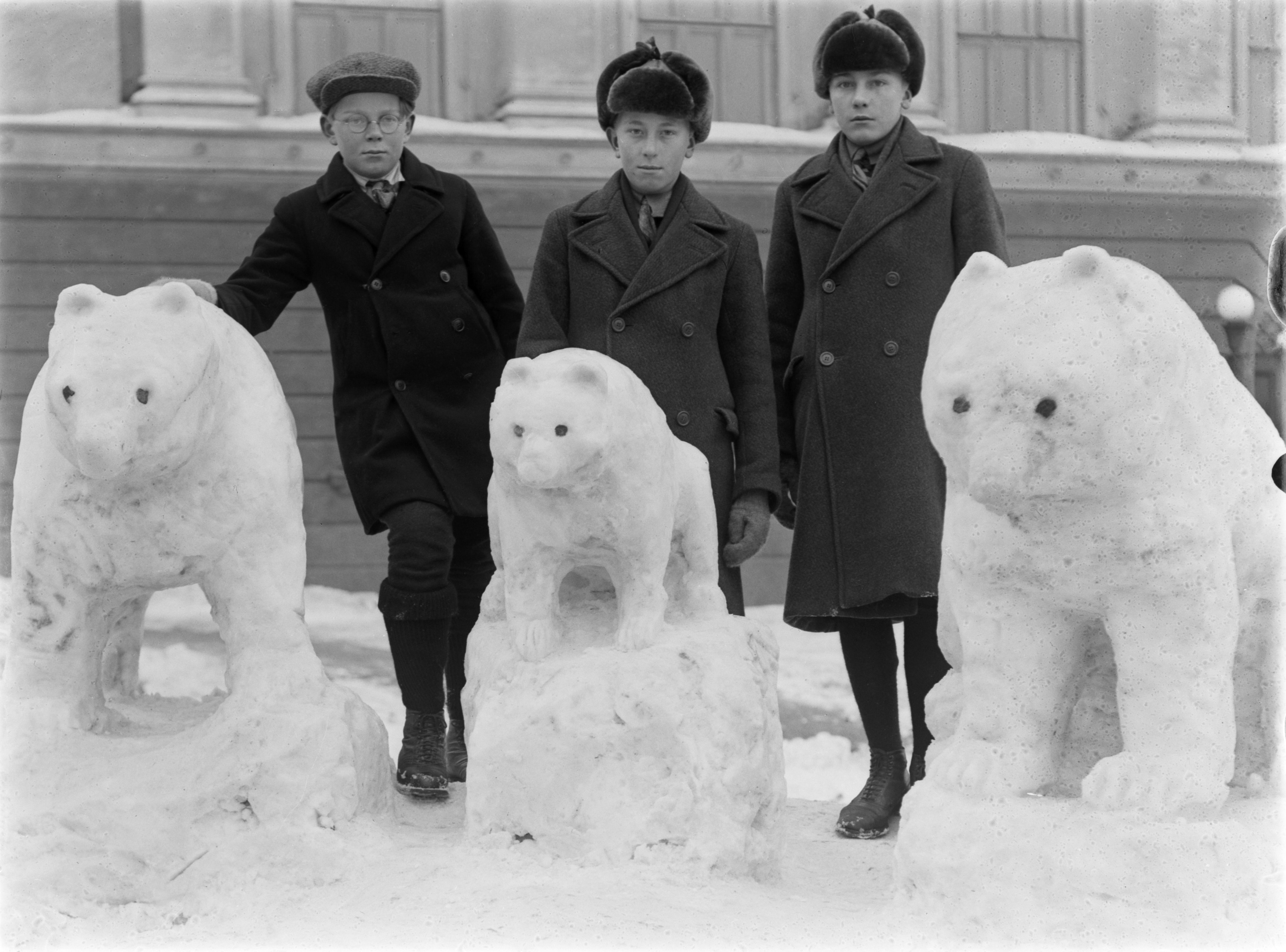 Kolme poikaa kolmen lumesta tehdyn karhun vierellä Agricolankadulla.