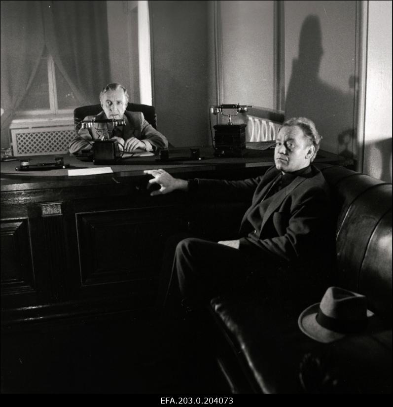 Stseen Tallinnfilmi mängufilmist "Bande". Istuvad Paul Madving (Aarne Üksküla) ja Ned Beamount (Tõnu Kark).