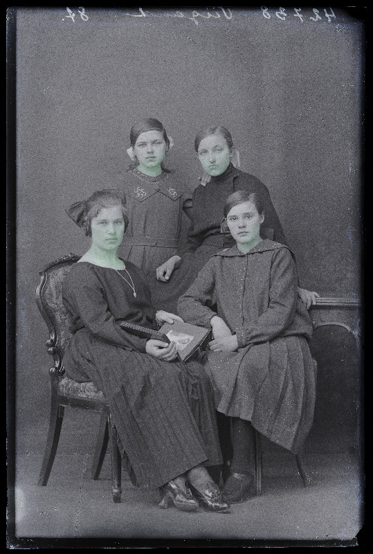 Grupp inimesi: paremal istub koolitüdruk Kohv, taga vasakul seisab koolitüdruk Pärn, (foto tellija Viigand).