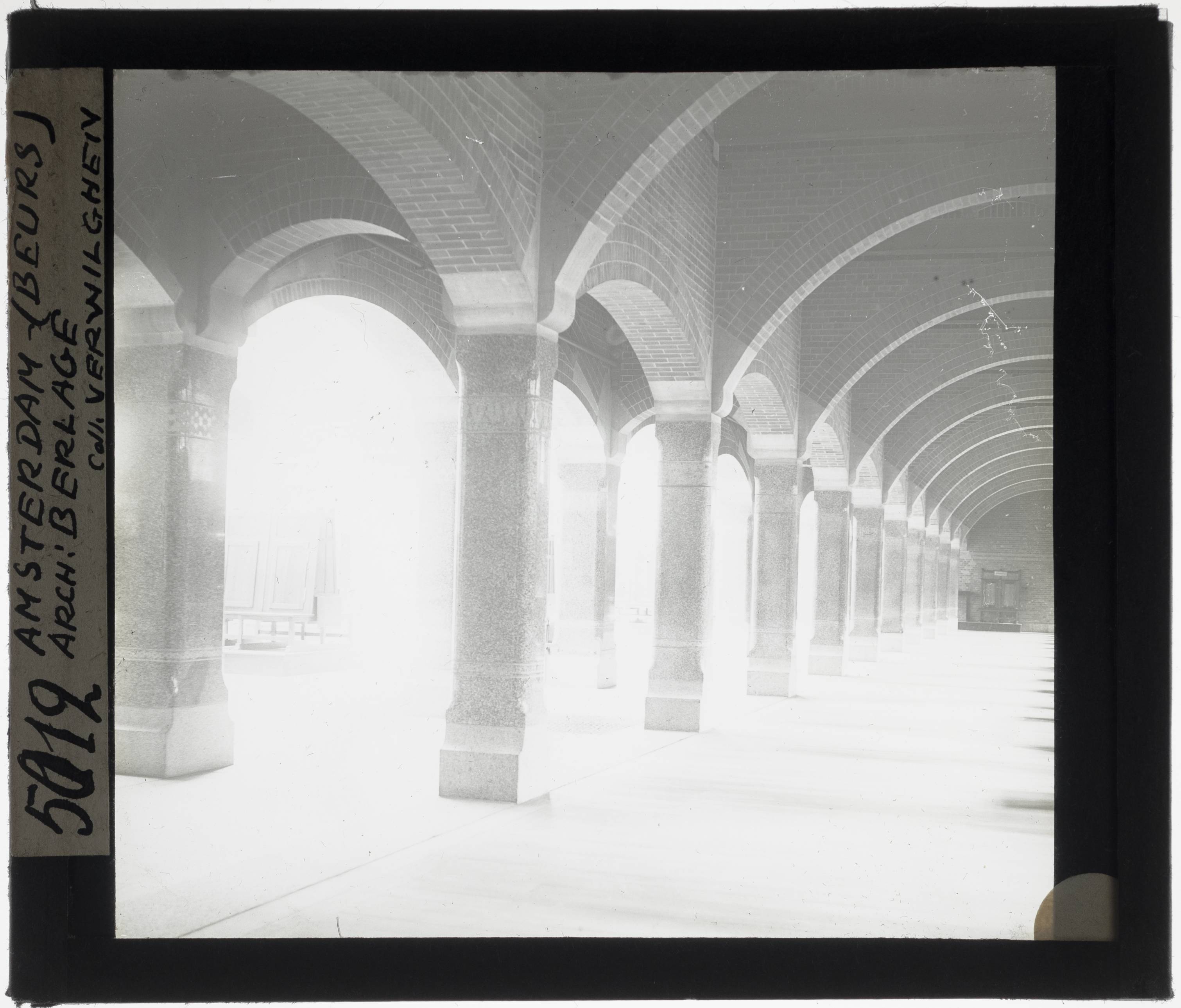 Amsterdam. Beurs van Berlage Interior: colonnade - KU Leuven. Glass slides landscape, architecture and design. Université de Louvain, between 1839 and 1939. Photographer unknown. Added information on slide. Current location: Netherlands, Amsterdam, Damrak and Beursplein. Current/Methods: Rationalism. Creation/Building: 1898-1903. EuroPhot. Art History. 19th century. Architecture. Building. EuroPhot. Art history. 19th century. Architecture. Building. EuroPhot. Social history. 19th century. Architecture. Building. EuroPhot. Social history. 19th century. Architecture. Building.