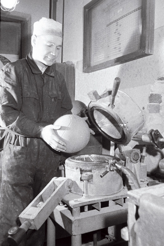 Kummitoodete vabriku Tegur meister E. Haavik eksperimentaal-vulkaniseerimisseadmel korvpalle valmistamas.