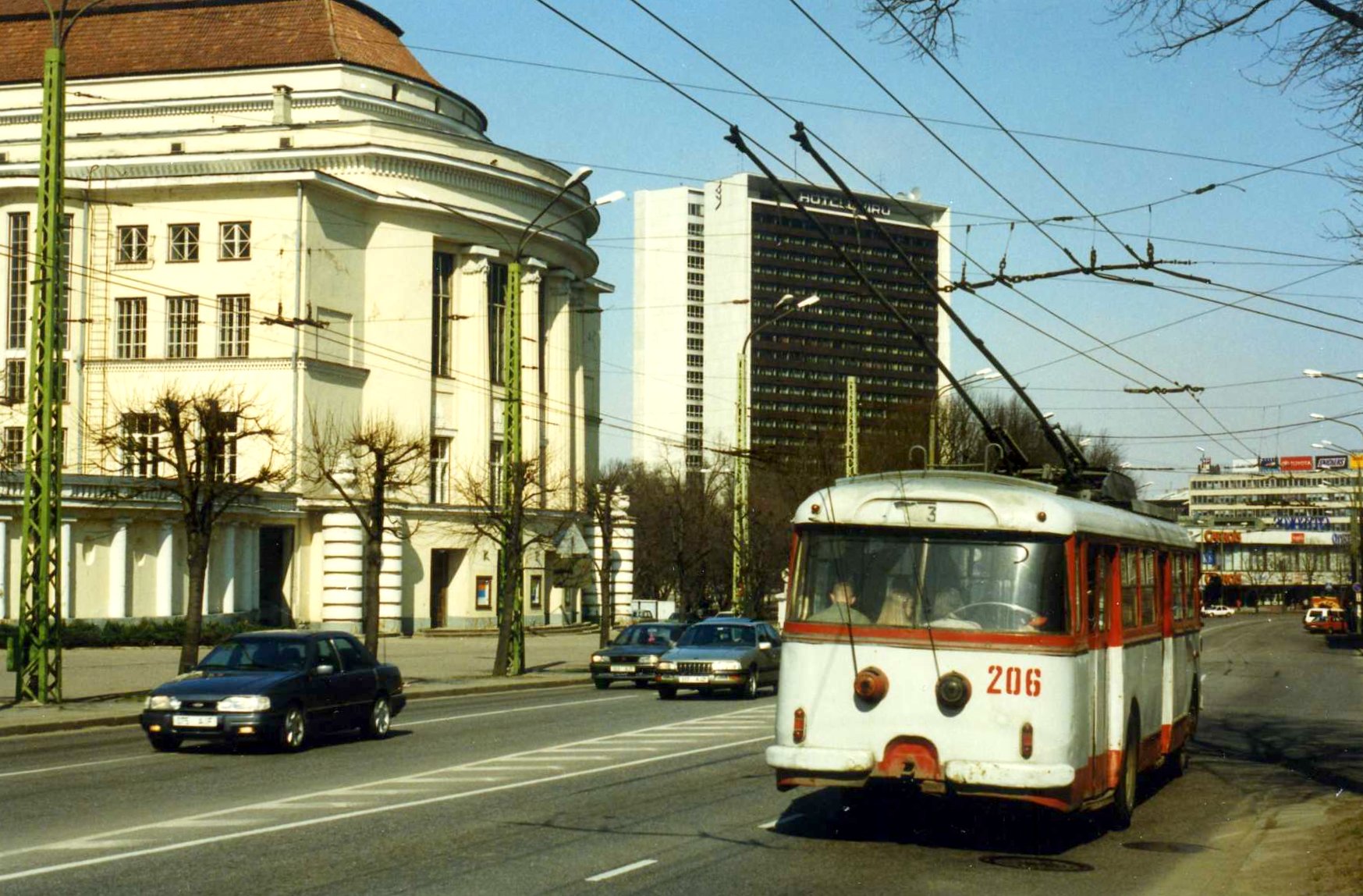 Tallinn,Estonia. TTTK Škoda 9Tr Trolleybus nr. 206. May 1996 - Skoda 9Tr No. 206. When it was deployed in Tallinn in 1983, it was new to TTTK (Tallinna Trammi-ja Trollibussikoondis), but one of the last of the 9Tr models deployed in the city. No. 206 was finally withdrawn from service in 1999.[1] By the year 2000, all the remaining 9Tr trolleys were decommissioned. In 1996, only about ten were in operation, including the venerable 92-numbered two-door model.


Route No. 3 connects Mustamäe and Kaubamaja.
In the background:


the "Estonia" theatre and concert building;
Hotel Viru. In 1996, the lower floors of the building housed

the "Stockmann" department store (sign at the top of the high-rise);
and the Carrols fast food restaurant.



The Carrols brand did not last very long. Either the Carrols restaurant left, or was converted into a Finnish-owned Hesburger restaurant. (For a while, Hesburger operated Carrols-branded fast food restaurants in Finland, but eventually converted nearly all of them to Hesburgers.)
Further back stands the "Teenindusmaja" building (eng.lit. Service House), which throughout 2002/2003 was reconstructed and converted into a hotel.