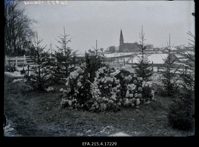 Selma Raua (Raud, sünd Heinrichson) pärgadega kaetud haud kalmistul, tagaplaanil Viljandi Pauluse kirik.