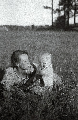 Naine väikese lapsega heinamaal