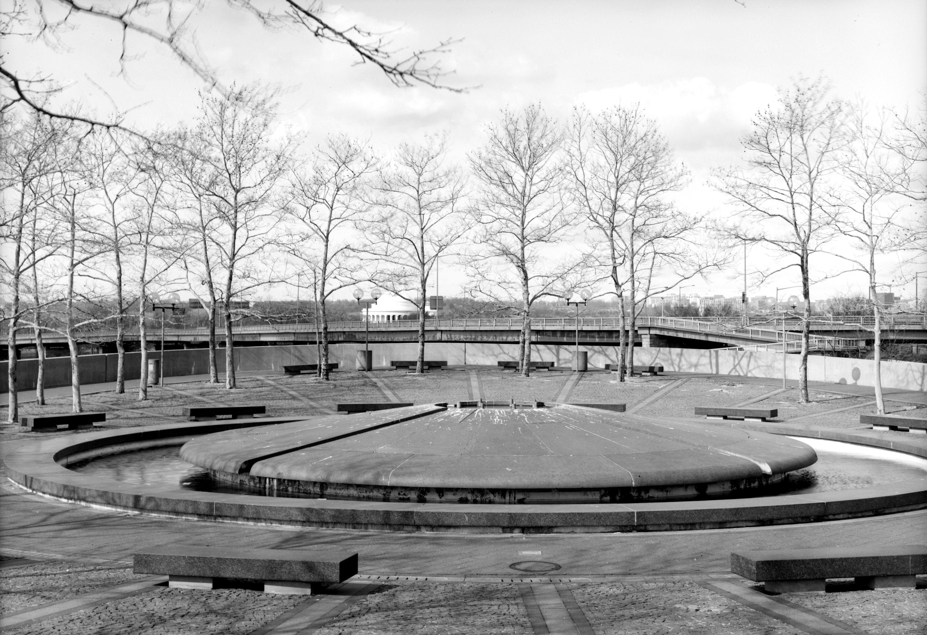 Banneker Park - Washington DC - facing east - Looking east over the fountain at Banneker Overlook, part of Benjamin Banneker Park in the Southwest quadrant of Washington, D.C., in the United States. The bridge in the middleground is the Francis Case Memorial Bridge, which carries Interstate-395 (the Southeast-Southwest Freeway) over the Washington Channel to East Potomac Park (and then on to the 14th Street Bridge over the Potomac River). The top of the dome of the Thomas Jefferson Memorial can be seen just over the horizon in the rearground.
