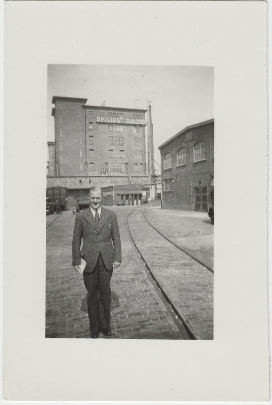 Tuvastamata mees [Eduard Virgo tuttav?] tehasehoone ["Philips Radio"] taustal