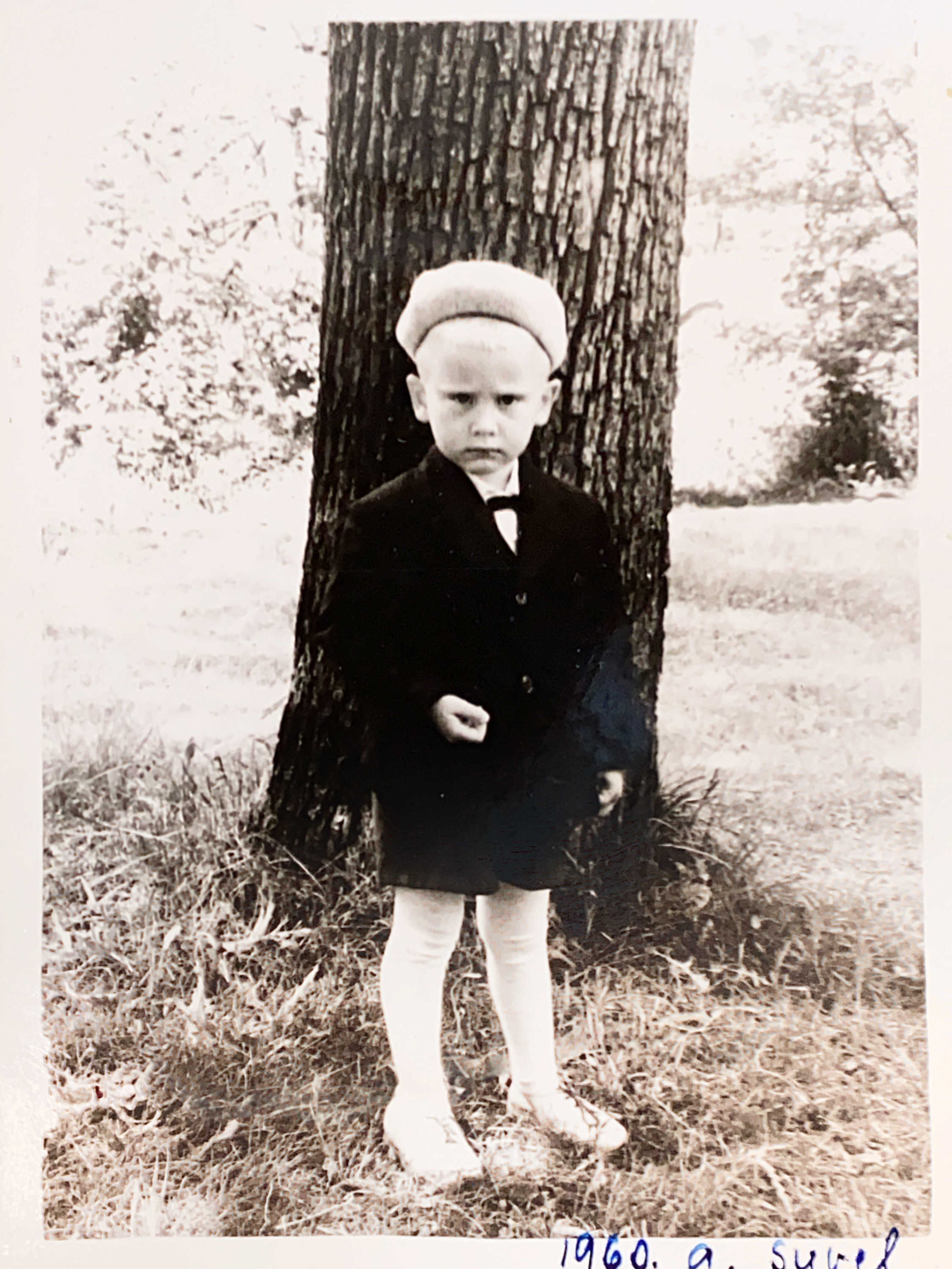 Boy standing in front of the tree