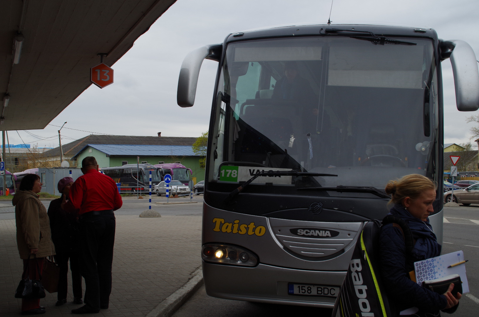 Ella Toomsalu (in the left) with its Canadian guests at Tallinn bus station, a line bus in the background. rephoto