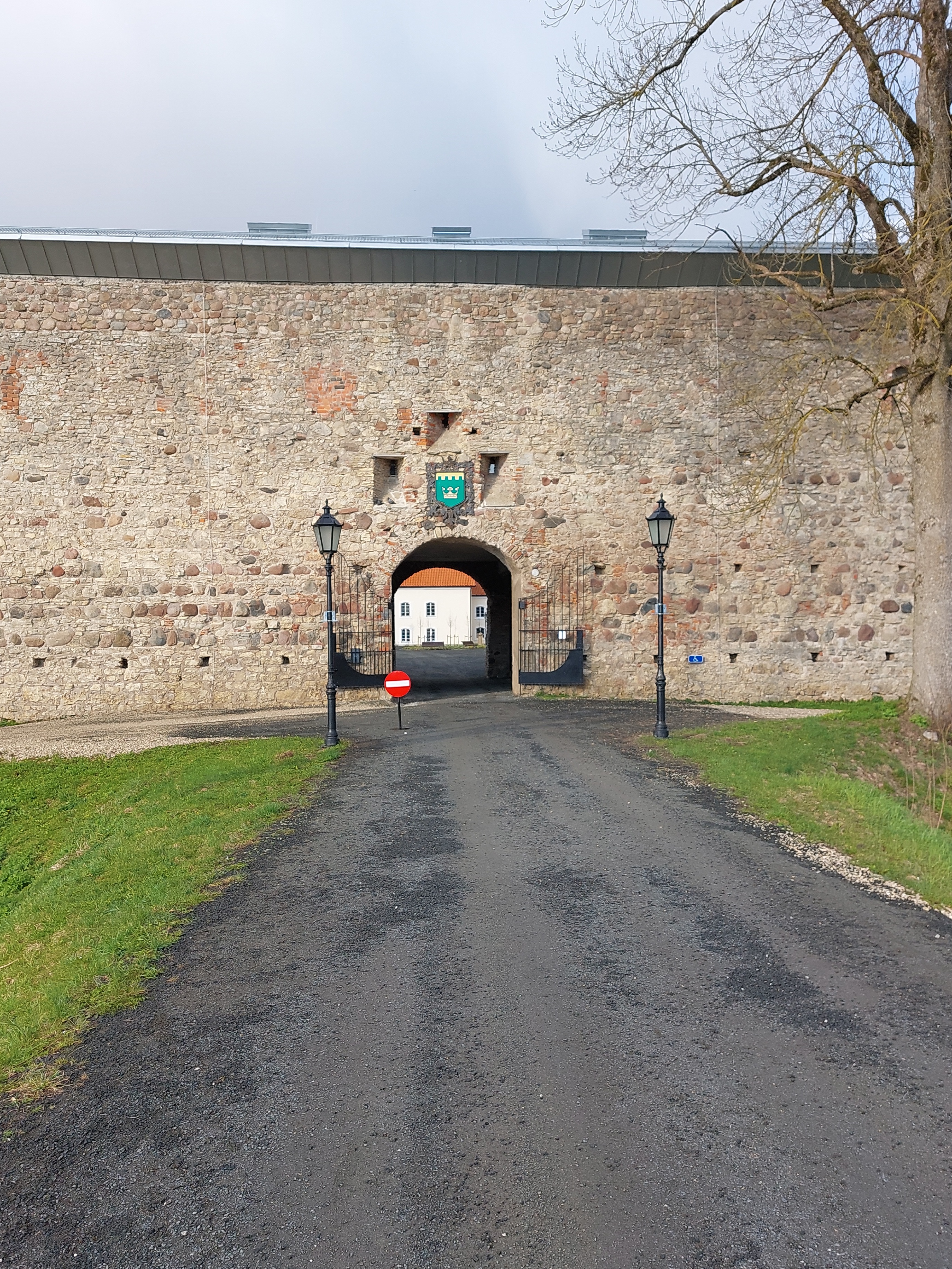 Põltsamaa itself. Ordinary castle courtyard gate with castle wall rephoto
