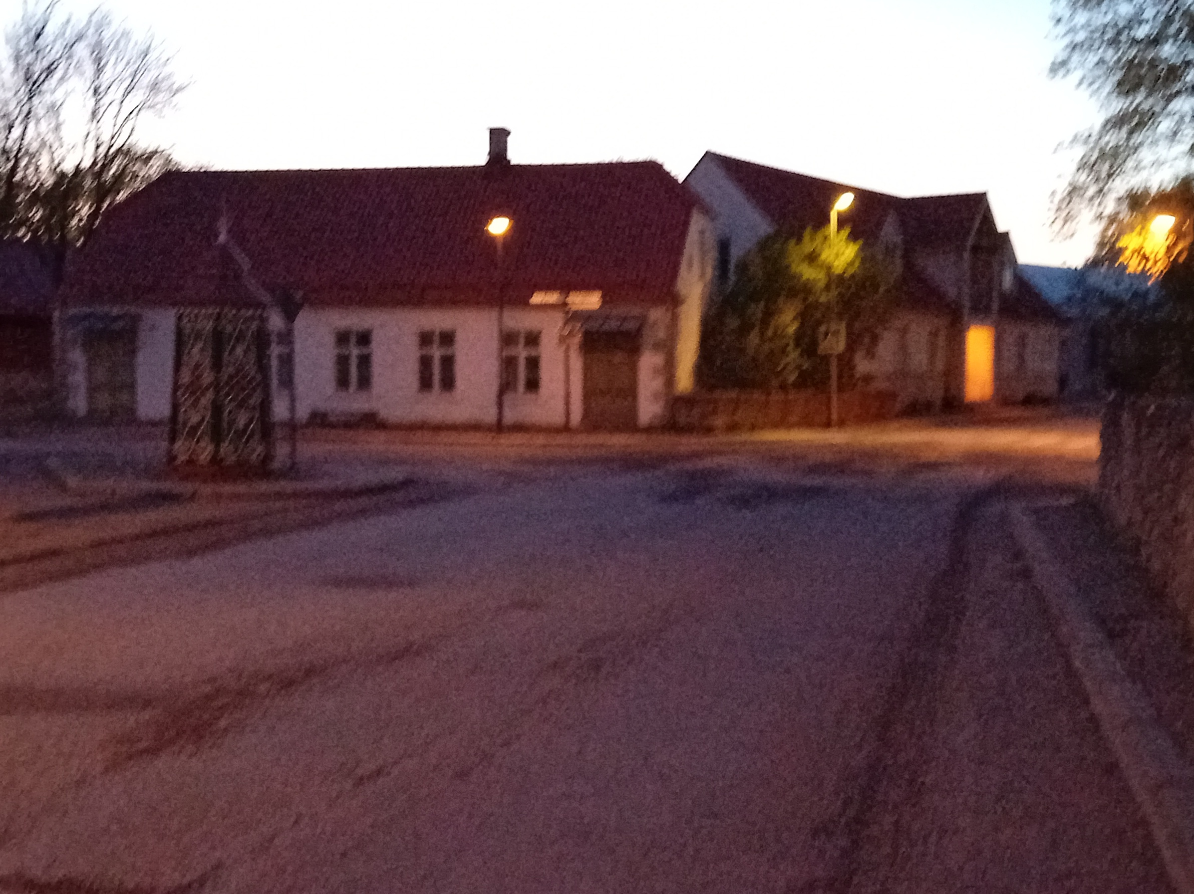 An old town yard with metal coating walls in Kingissepa. rephoto