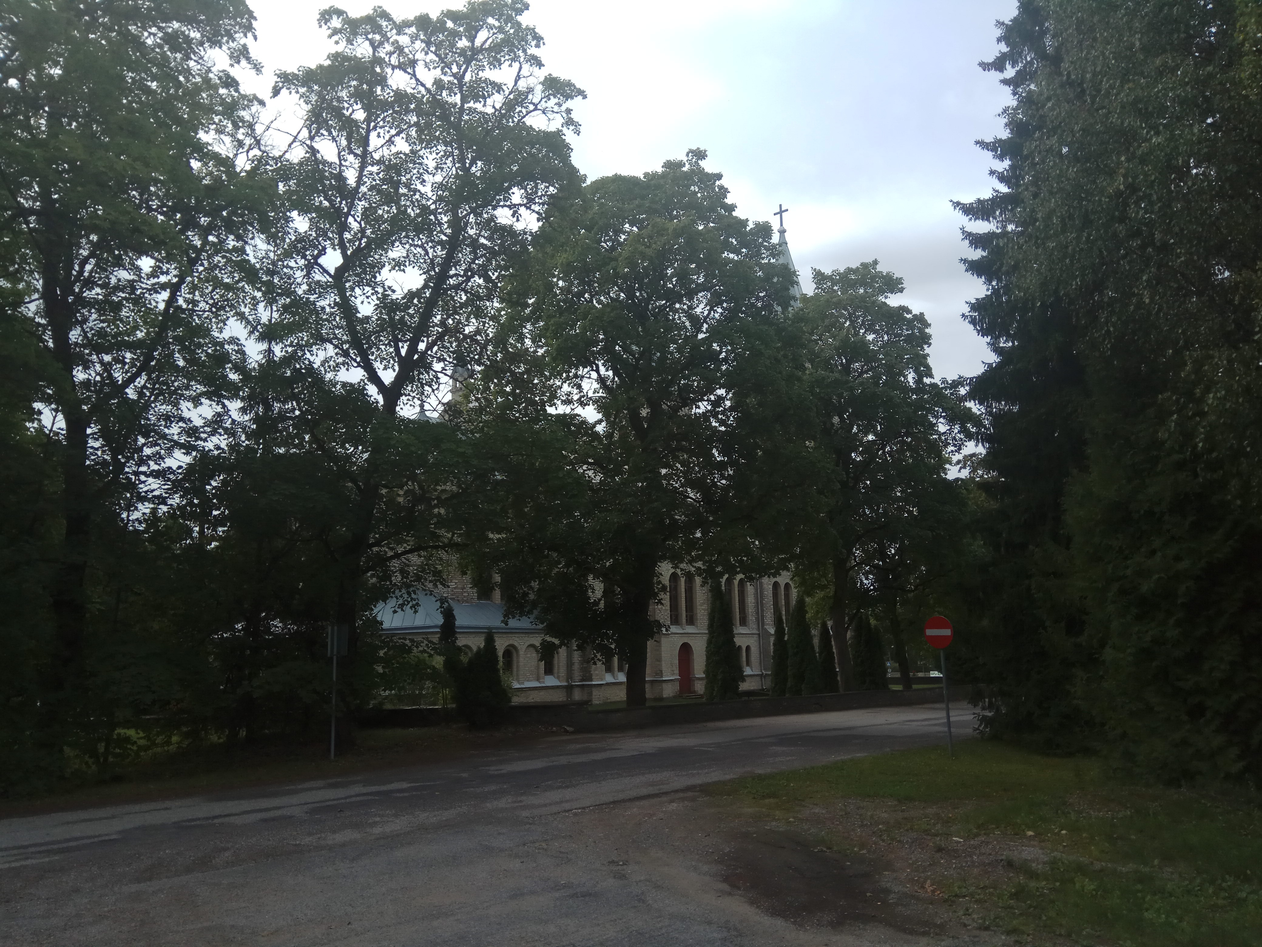 Rapla Church. View from the southeast. In the middle of the order, church building with two towers. At the forefront of the arable peppers. rephoto