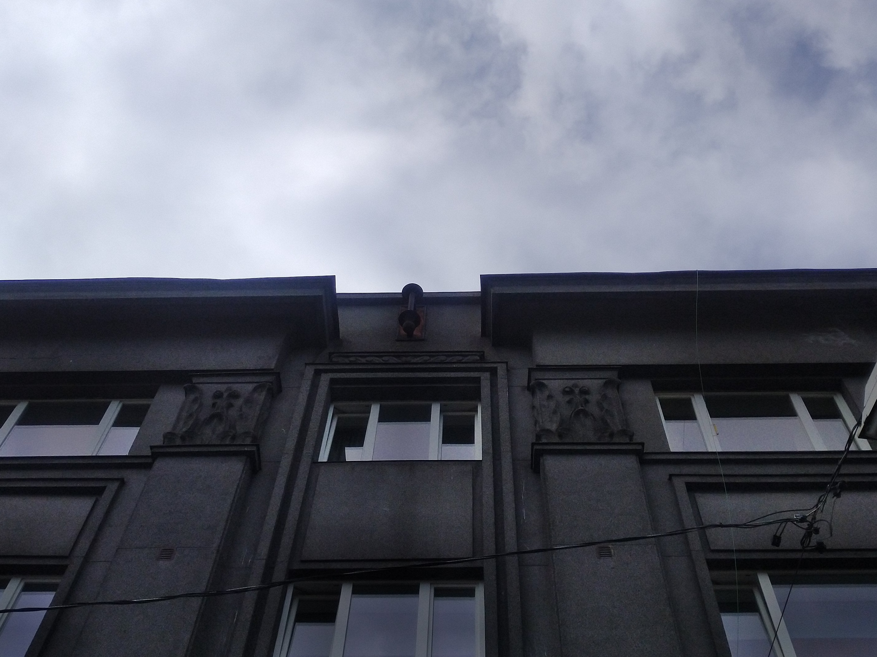 Apartment building with shops in Tallinn, Tatari 6, on the facade floor - the top side of the house with flag belts and captains; pictured from the lift. Architect Eugen Sacharias rephoto