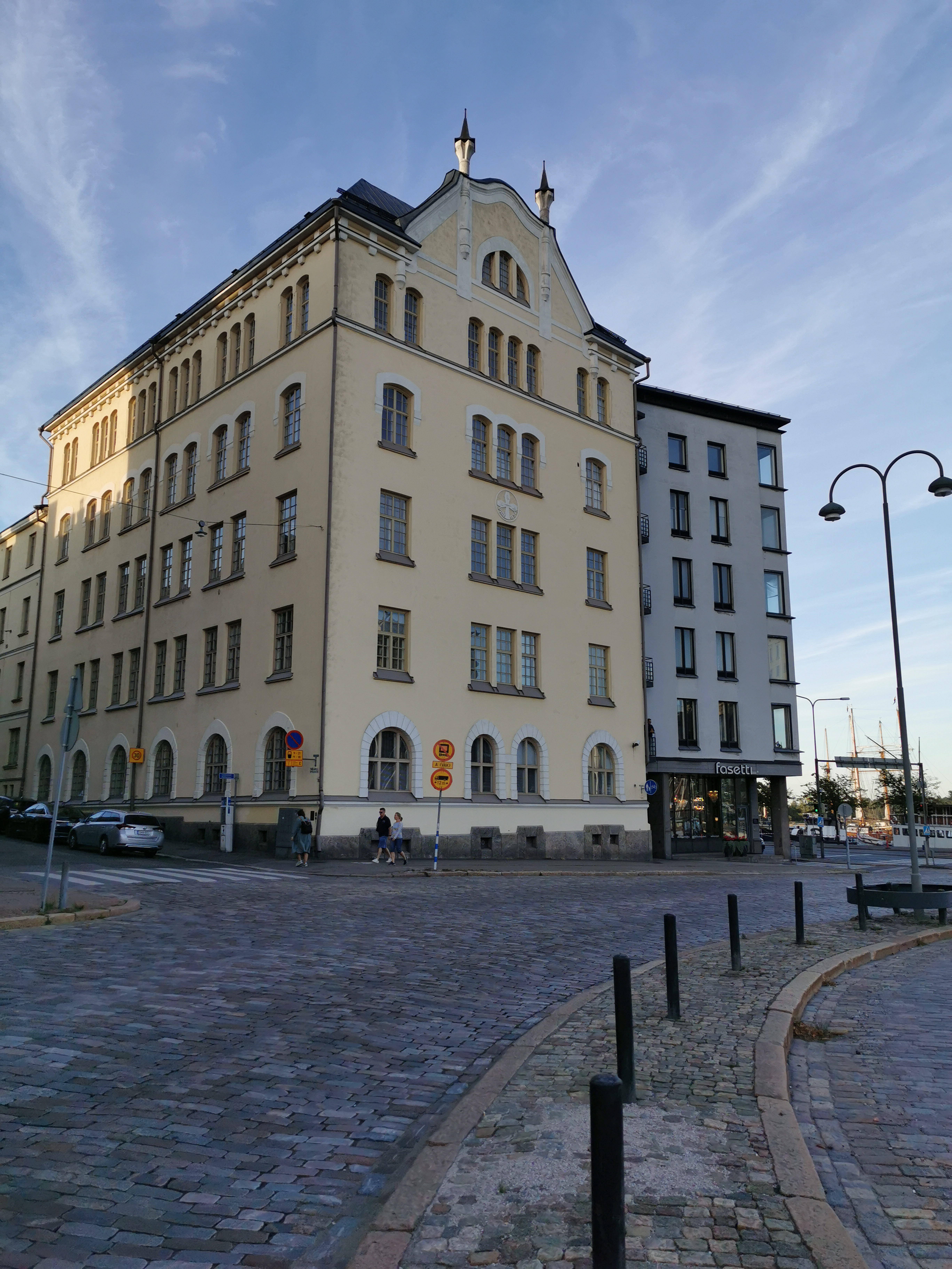 Helsingin valtauksen jälkeen kuvattuja pommitusvaurioita. Borgströmin tupakkatehtaan vaurioituneet seinät, etualalla jalankulkijoita. Meritullintori 1, Meritullinkatu 1. rephoto