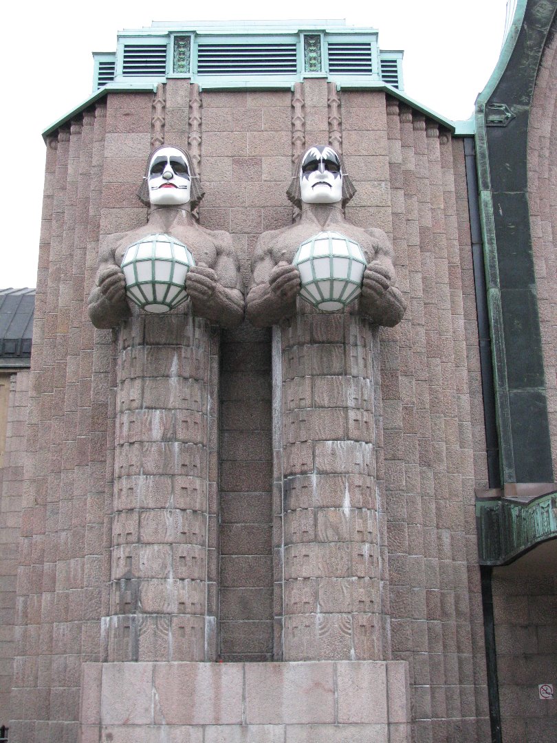 Kaivokatu 1. Kuvanveistäjä Emil Wikströmin veistämät graniittiset Lyhdynkantajat-hahmot Helsingin rautatieaseman pääsisäänkäynnin vasemmalla puolella. rephoto