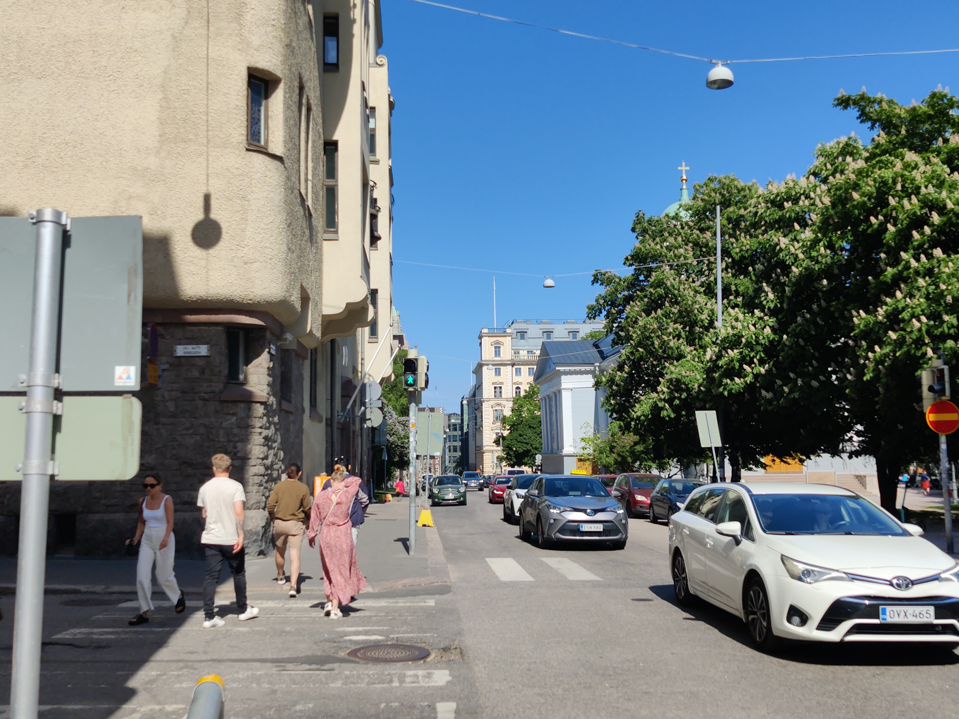 Näkymä Antinkatua (=Lönnrotinkatu) pitkin itään, vasemmalla nro:t  7 (=Annankatu 19) ja 5, oikealla nro 6, Vanha kirkko. rephoto