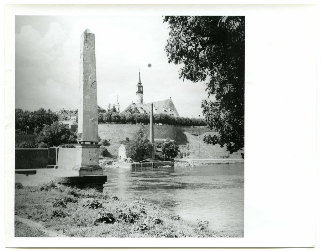 Wooden bridge across the Narva River. Right-wing obelisk bridge in the east end. The Old Town, the tower of the church of Jaan