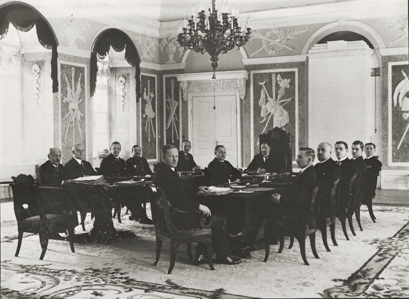 Eesti Vabariigi valitsuse koosseis Toompea lossi valges saalis (16. detsembril 1924. aastal loodud Jüri Jaaksoni kabinet) vasakpoolne laud (vasakult) R. Gabriel, A. Keren, H. B. Rahamägi, J. Soots, K. Einbund; parempoolne laud (vasakult) A. Oinas, K. Ast, K. Virma, Chr. Kaarna, L. Sepp, A. Birk; laua otsas riigivanem J. Jaakson, tema vastas riigisekretär K. Terras.