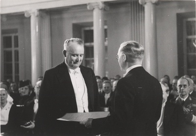 Õpetatud Eesti Seltsi esimees professor Harri Moora (paremal) annab seltsi 100. a juubeli puhul sõjavägede ülemjuhatajale kindralleitnant Johan Laidonerile üle seltsi auliikme diplomi.  similar photo