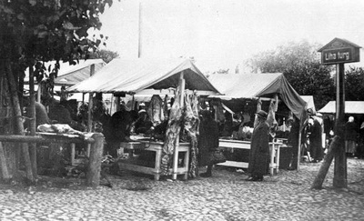Lihaturg: müügiletid, turulised. Infopostil silt: Liha turg.
Munakivisillutis.
Tartu, 1920.-1930. aastad.  duplicate photo