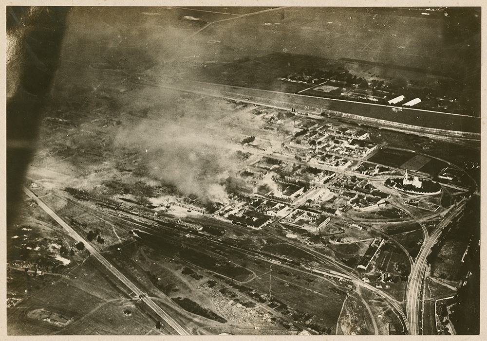 [aerial view of a burning munitions factory]