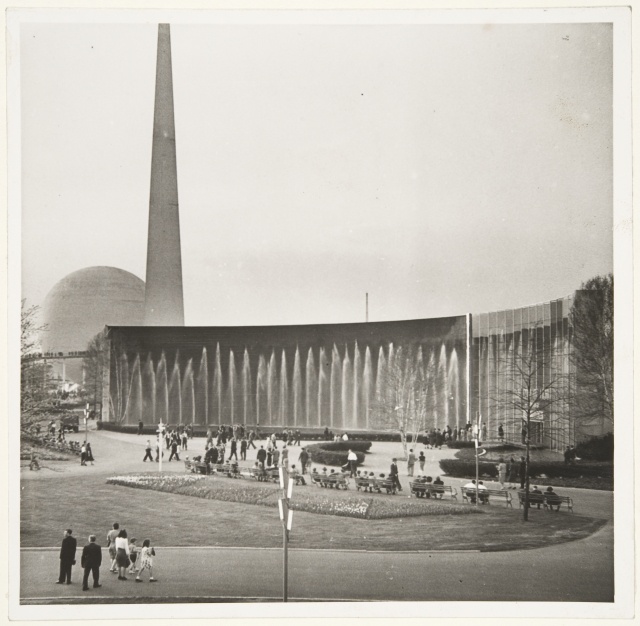 The audience in the New York World Exhibition; behind the exhibition thematic building The Perisphere and Trylon