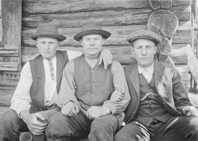 Three young men dressed in Estonian and Russian style