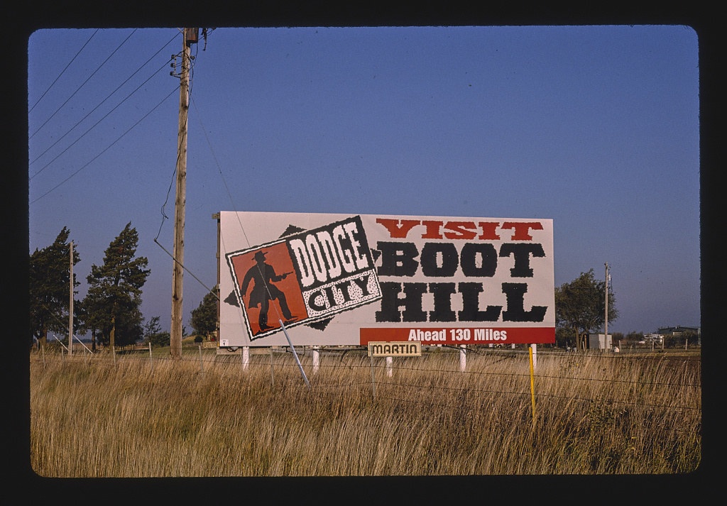 Billboard: "Visit Boot Hill, Dodge City, 130 miles," near Goddard, Kansas (LOC)