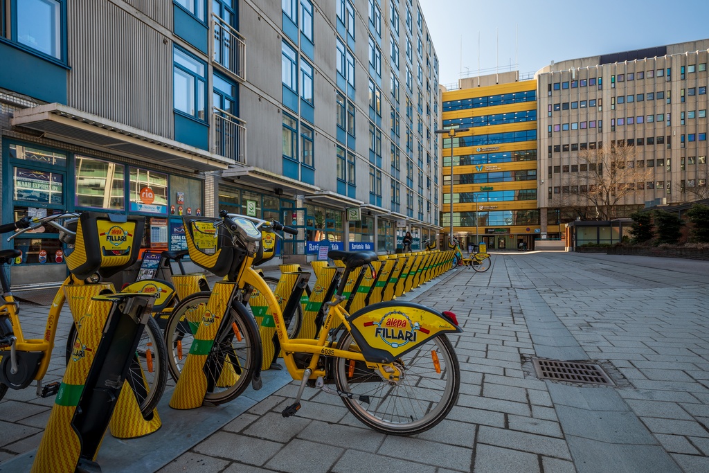Alepa bikes on Opastinsilta in Itä-Pasila, Helsinki, Finland, 2022 May - Alepa bikes on Opastinsilta in Itä-Pasila, Helsinki, Finland in 2022 May. The apartment building on the left is Opastinsilta 10 from 1974. In the background is Pasila Office Centre from 1981.