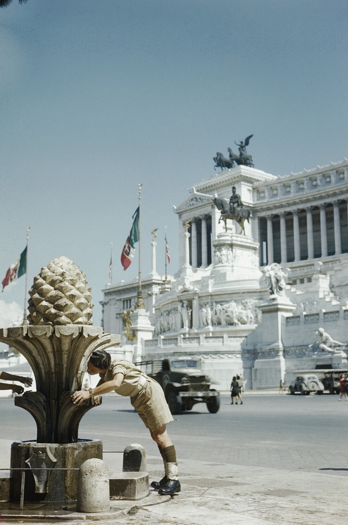 The British Army on Leave in Italy, June 1944 TR1971 - The British Army on Leave in Italy, June 1944
'A Day in Rome with Gunner Smith': Gunner Smith quenching his thirst at a fountain in the Piazza Venezia. In the background is the Vittorio Emmanuel Memorial.