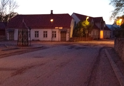 An old town yard with metal coating walls in Kingissepa. rephoto