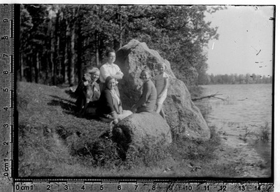 Clothing for men, women and children - company with a dog at Kalevipoja stone ? Near Lake Saadjärvi  similar photo