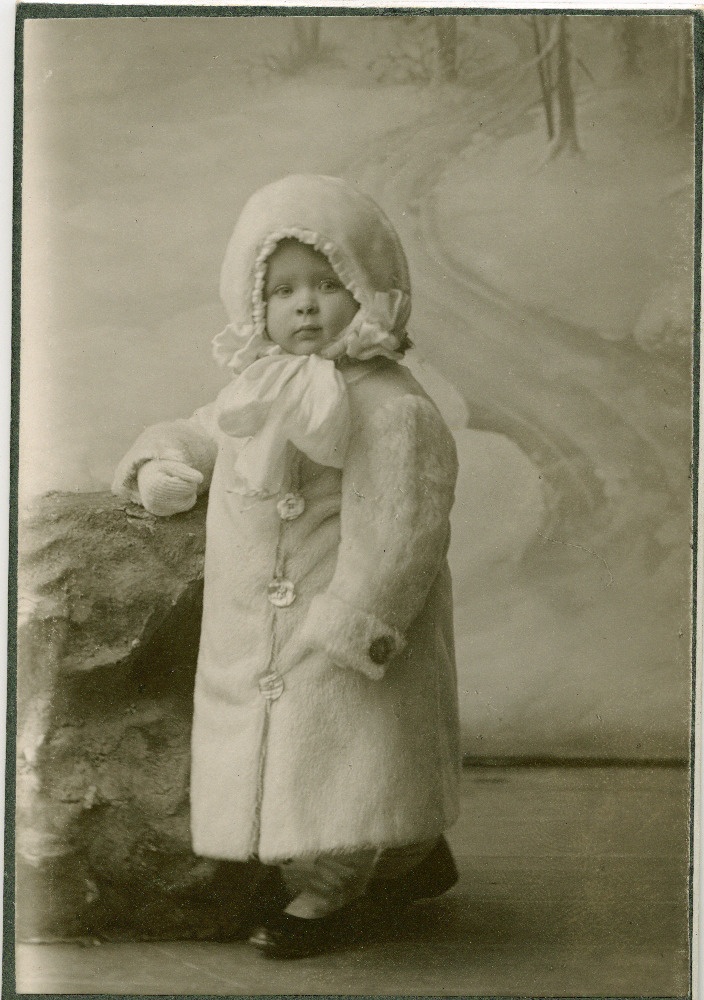 Stuudiofoto lapsest talveriietes (valges kasukas), ilmselt üks Tõnissonide lastest