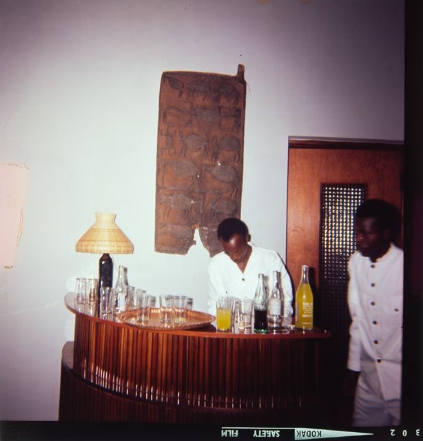 Bartender, servants and wooden relief; interior picture