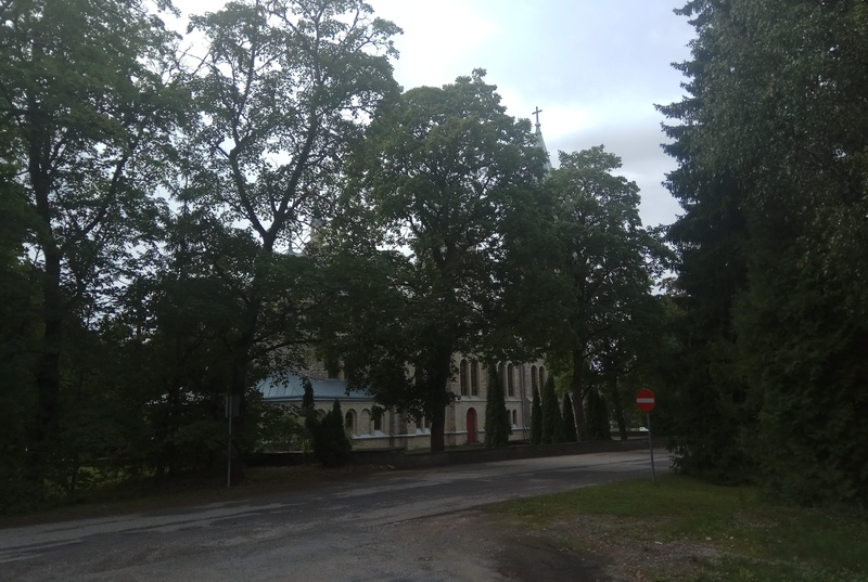 Rapla Church. View from the southeast. In the middle of the order, church building with two towers. At the forefront of the arable peppers. rephoto