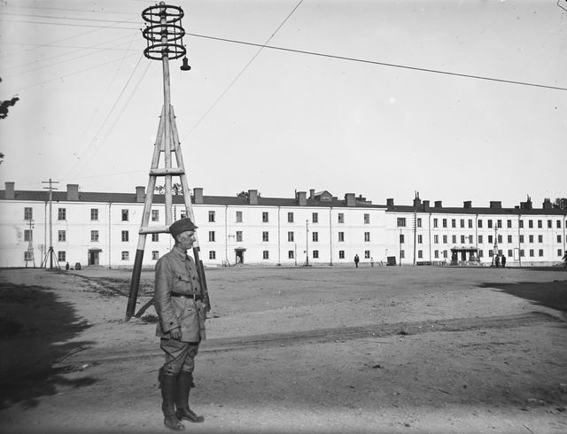 The soldier stands next to the Kurtish houses in Finland